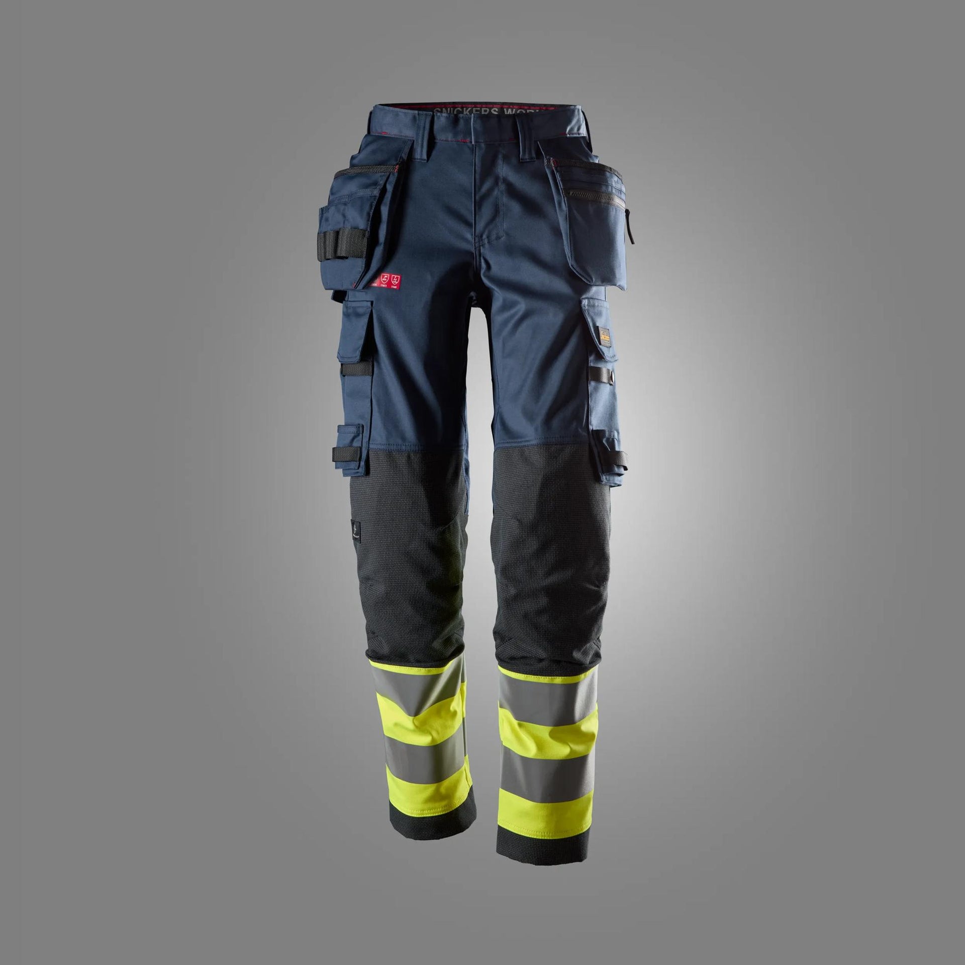 ProtecWork, naisten stretch-huomiotyöhousut riipputaskuilla, luokka 1 - Navy/High Visibility Yellow